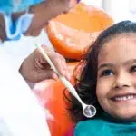 happy smiling kid looking at dentist