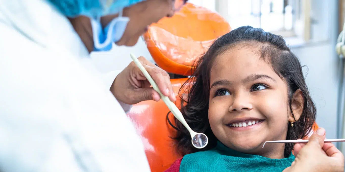 happy smiling kid looking at dentist