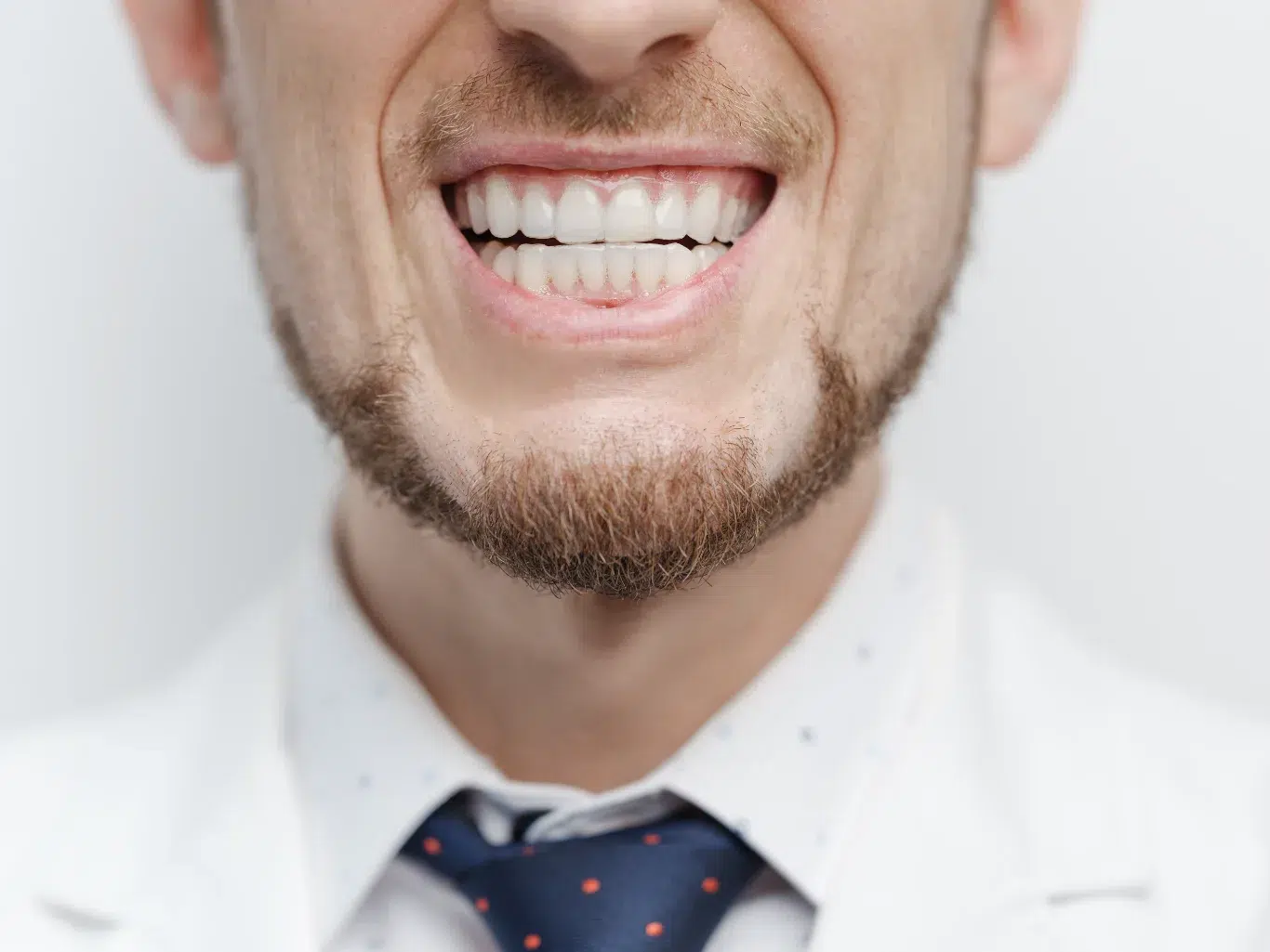 Bruxism 1 Closeup shot of male mouth with clear aligners on his teeth