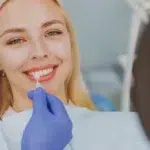 happy woman choose veneers enamel color compare teeth shade